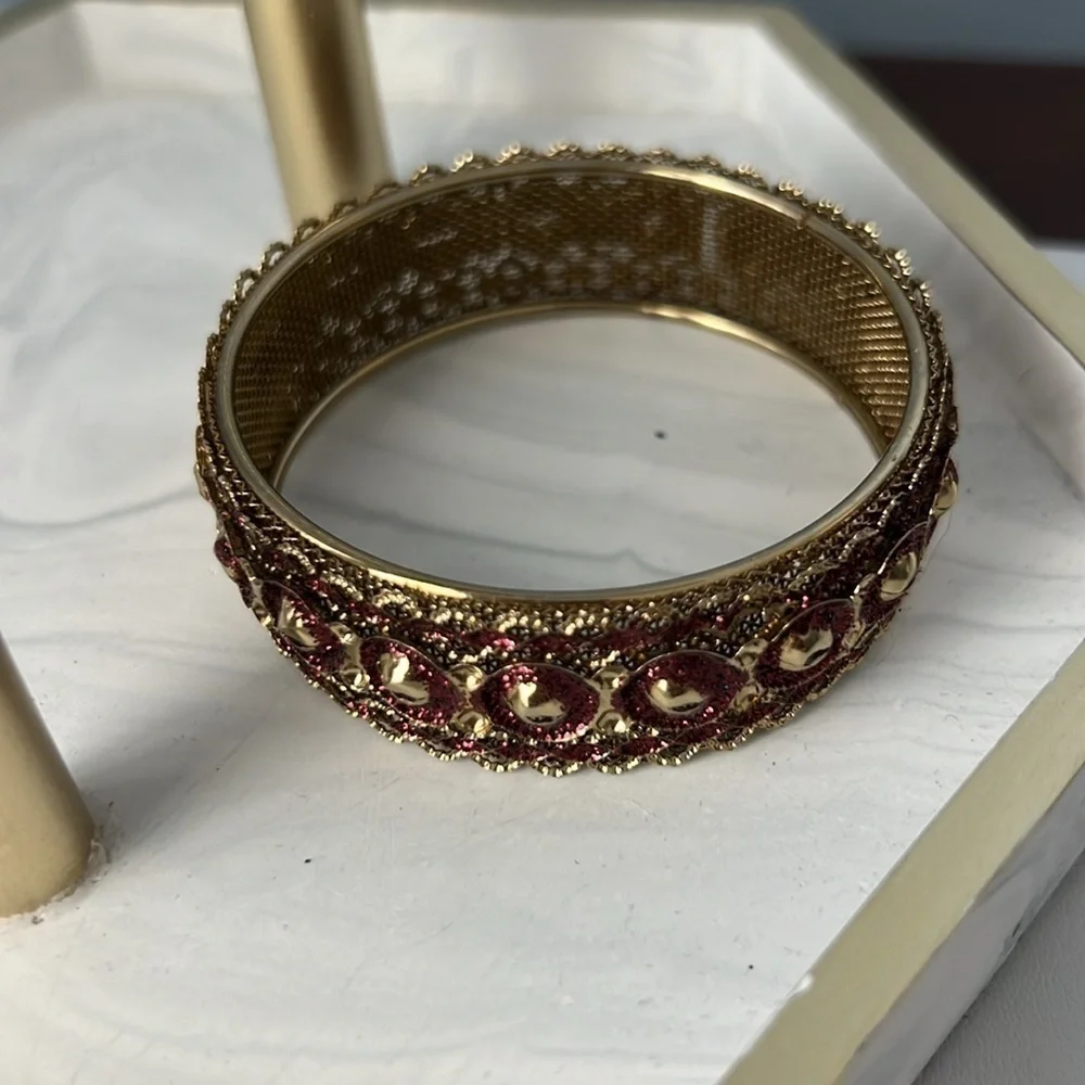 Gold filigree bangle with red accents